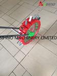 Hands Pushing Small Manual Grain and Beans Seeder
